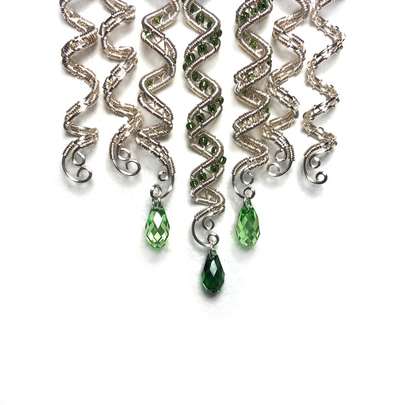 Handmade silver hair twist with customizable beads for braids.