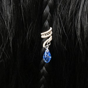 Bohemian-inspired silver hair wrap with dangling bead, adding elegance to bridal hair