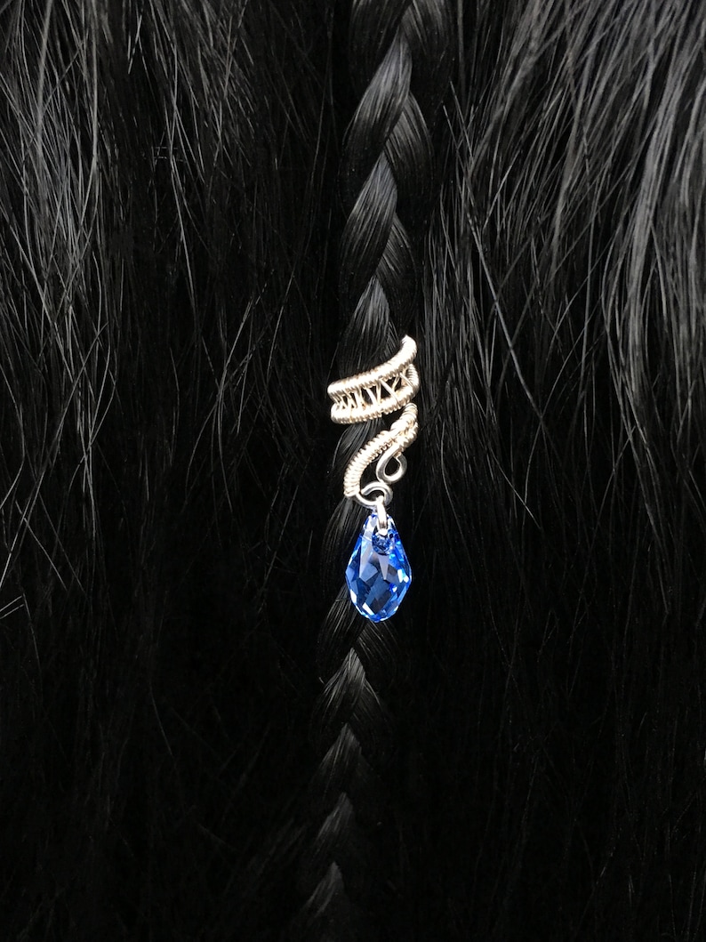 Bohemian-inspired silver hair wrap with dangling bead, adding elegance to bridal hair