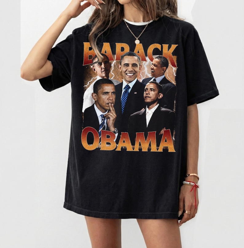 May include: Black t-shirt featuring a collage of Barack Obama images with the text "BARACK OBAMA" in orange and yellow. The shirt has a vintage, distressed look.