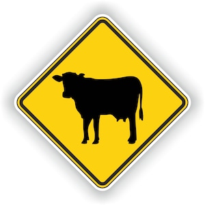 May include: A yellow diamond-shaped warning sign with a black silhouette of a cow. The sign is used to warn drivers of livestock crossing the road.