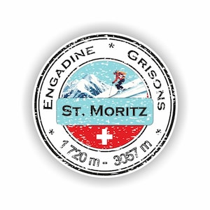 May include: A round sticker featuring a skier on a snowy mountain, with the text "ST. MORITZ" on a blue banner. The sticker also includes the text "ENGADINE GRISONS" and the Swiss flag, with altitude details of 1720 m - 3057 m.