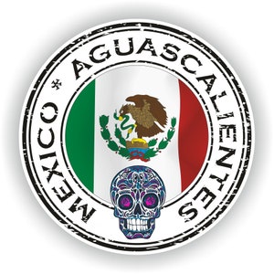 May include: A round, black and white stamp with the text "MEXICO*AGUASCALIENTES" around the edge. The centre of the stamp features the Mexican flag and a colourful sugar skull.