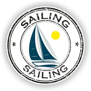 May include: A black and white distressed circle stamp with the word "SAILING" written around the edge. Inside the circle is a blue sailboat with a white sail and a yellow sun.