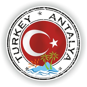 May include: A round sticker with the words "TURKEY ANTALYA" in a black, distressed font. The center features the Turkish flag with a crescent moon and star, plus a small island with palm trees and a sunset.