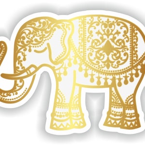 May include: A gold-colored elephant silhouette with intricate floral patterns and decorative details. The elephant is standing on a white background.