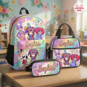May include: A backpack, lunch bag, and pencil case set featuring a pastel rainbow background with cartoon characters and the name Sophia printed in a cursive font. The items display a purple rabbit, a jester, and a red-haired doll character.