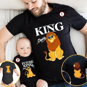 May include: Black t-shirts with matching lion graphics. One shirt says "KING Daddy" with a lion wearing sunglasses. The other says "FUTURE KING" with a lion graphic. A baby onesie with a lion graphic is also shown.