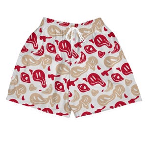 Könnte beinhalten: Weiße Shorts mit einem Muster aus roten und beigefarbenen Smiley-Gesichtern. Die Shorts haben einen Kordelzug in der Taille. Das Muster zeigt sich wiederholende geschmolzene Smiley-Gesichter und abstrakte Formen. Ein Freizeitkleidungsstück.