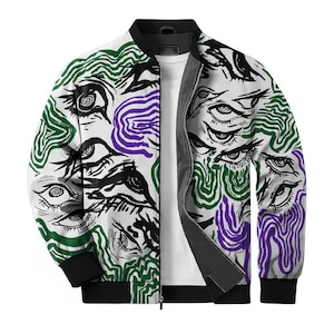 May include: A white bomber jacket featuring a repeating graphic print of black ink-style eyes interspersed with wavy, abstract lines in shades of forest green and deep purple. The jacket has a black ribbed collar, cuffs, and a full-length front zipper.