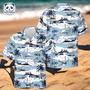 May include: Light blue Hawaiian shirt featuring a tropical beach scene with palm trees, airplanes, and small houses. The shirt has a button-down front and short sleeves. The PixelPanda Studios logo is visible in the upper left corner.