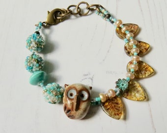 Dappled Dew - handmade artisan bead bracelet with handmade ceramic owl and handwoven glass rounds in mint aqua green and topaz pale brown