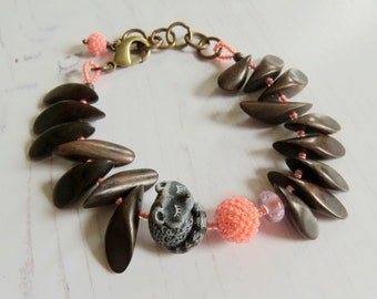 Handmade artisan raccoon bead bracelet in black, brown and neon coral - Rocky - Songbead, UK, narrative jewelry