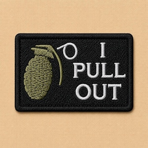 May include: Black rectangular patch with a green grenade graphic and the words "I PULL OUT" in white. The patch has a black border and is set against a tan background.