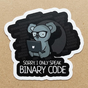 May include: A sticker featuring a gray koala wearing glasses and using a laptop. The koala is surrounded by binary code and the text "SORRY, I ONLY SPEAK BINARY CODE" in white on a black background.