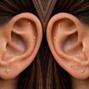 May include: A set of gold starburst stud earrings featuring multiple small, pointed designs. Each earring is shaped like a radiant star with thin, sharp rays extending from a central point, creating a celestial look on the earlobes.