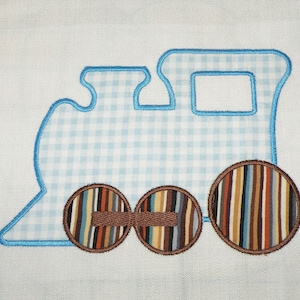 May include: Blue and white gingham train applique with brown and multi-colored wheels.