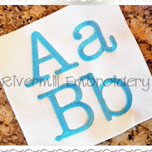 May include: Embroidered letters "A" and "a" in a light blue color, with the word "Bro" embroidered in the same color below.