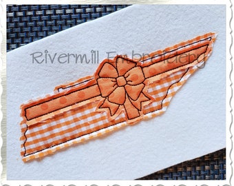 May include: Orange and white gingham fabric in the shape of the state of Tennessee with a large orange bow on top. The fabric has a polka dot pattern. The text "Rivermill Embroidery" is visible in the background.