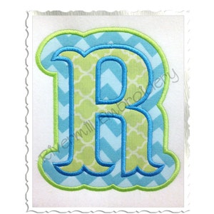 Könnte beinhalten: Ein grüner und blauer Buchstabe R mit weißem Umriss. Der Buchstabe ist in einer fetten, abgerundeten Schriftart.