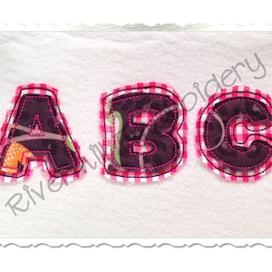 May include: Three felt letters, A, B, and C, in a pink and white gingham pattern. The letters are outlined in pink thread and have a black and white camouflage pattern inside.