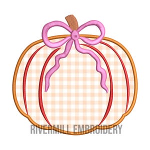 May include: A pink and orange pumpkin with a pink bow. The pumpkin has a gingham pattern.