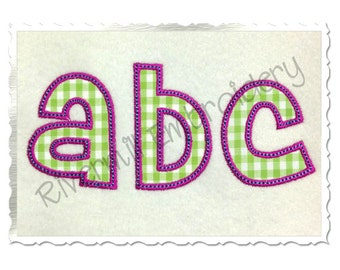 May include: Embroidered letters "abc" in a green and white gingham pattern with a pink outline.