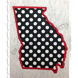 May include: A red outline of the state of Georgia with a black and white polka dot pattern inside.