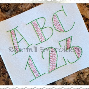 May include: Embroidered letters A, B, C, 1, 2, and 3 in a green outline with a red and white striped fill. The letters are in a stylized font. The text "Rivermill Embroidery" is visible in the lower left corner of the image.