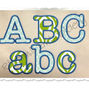 May include: Embroidered uppercase and lowercase letters A, B, and C in a playful font. The letters have a blue outline and are filled with a patterned design in light blue and green. The background is a light beige.