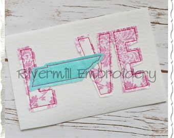 May include: Embroidered design of the word "LOVE" with the state of Tennessee in the center of the "O". The letters are pink with a white damask pattern and a red outline. The state of Tennessee is turquoise blue.
