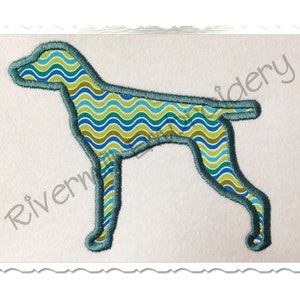 May include: A blue and green patterned dog silhouette embroidery design. The design is outlined in blue.