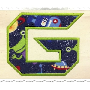 May include: Green, blue, and red fabric letter G with a space theme. The letter is outlined in green and has a white background.