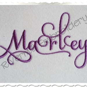 May include: Purple embroidered cursive font spelling the name "Macrley".