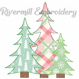 May include: Three Christmas trees with different patterns. The tallest tree is pink and green plaid, the middle tree is light blue with white snowflakes, and the smallest tree is green with white snowflakes.