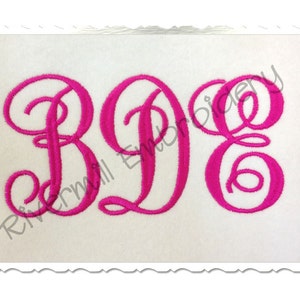 May include: A monogram with the letters B, D, and E in a cursive script font. The letters are pink and are embroidered on a white fabric.