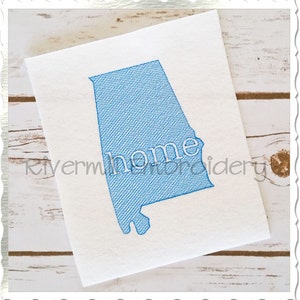 May include: A blue embroidered outline of the state of Alabama with the word "home" inside. The embroidery is on a white background.