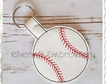 May include: White leather baseball keychain with red stitching. The keychain has a silver key ring.