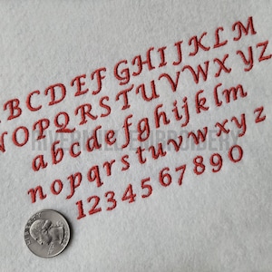 May include: A red embroidered font alphabet with uppercase and lowercase letters and numbers 1 through 9. The letters are in a cursive style.