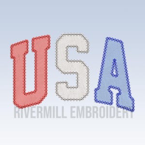 May include: USA embroidered in red, white, and blue fabric with a stitched border. The letters are in a bold, blocky font. The text "Rivermill Embroidery" is below the letters.