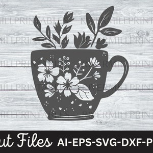 May include: A black and white silhouette of a coffee mug with a floral design and a leafy stem extending from the top. The text "Cut Files AI-EPS-SVG-DXF-PNG" is below the mug.