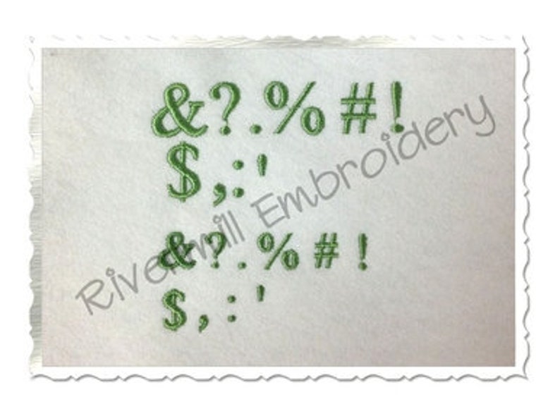 May include: Green embroidered font with the characters & ? . % # ! $ : , on a white background.
