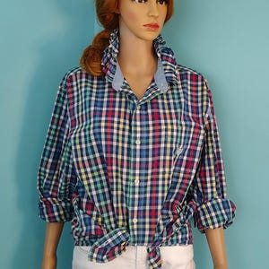 May include: A white ceramic mug with a black handle and the text "But First, Coffee" in a handwritten style. The mug is on a white surface.