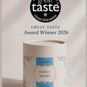 May include: A cylindrical white cardboard container for Early Night organic tisane blend for deep sleep. The label features a blue vertical stripe with decorative floral line art. Above the container, a black Great Taste Award Winner 2026 logo.