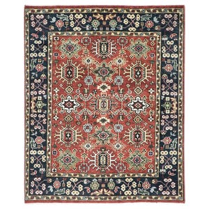 May include: A rectangular area rug with an intricate geometric pattern. The rug features a central field of reddish-brown with repeating shapes in white, green, and black. A dark blue border with floral and geometric motifs frames the design.