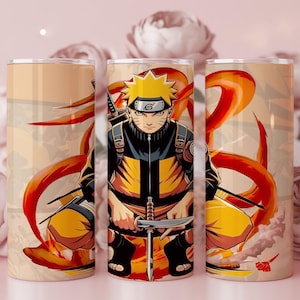 May include: Three cylindrical tumblers featuring a Naruto anime character in a dynamic pose. The character is depicted in yellow and black attire, with orange and red accents. The background is a soft beige with floral elements.