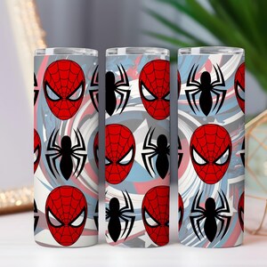 Op de afbeelding: Drie roestvrijstalen bekers met een herhalend patroon van Spider-Mans masker en een zwart spinnenembleem. De achtergrond heeft een wervelend ontwerp in tinten rood, wit en blauw.