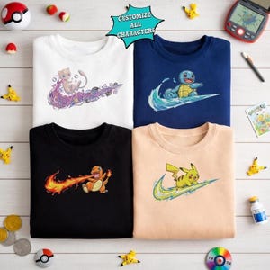 May include: Four sweatshirts in white, navy blue, black, and tan, each featuring a different cartoon character design within a swoosh. The text "CUSTOMIZE ALL CHARACTERS" is in a teal bubble.