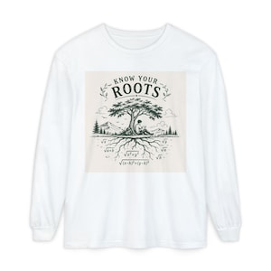 May include: A white long-sleeve t-shirt featuring a graphic print of a tree with roots depicted as mathematical square root equations. The text "KNOW YOUR ROOTS" is printed above the tree, which sits over a landscape with a person reading.