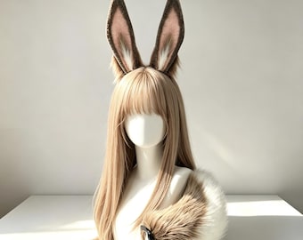 May include: A mannequin head wearing a long, straight, light blonde wig with fringe and a pair of tall, pointed, brown and white faux fur animal ears. A matching, thick, fluffy brown and white faux fur tail is positioned at the base.